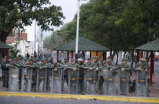 Venezuelan forces fire tear gas at crowd demanding to cross bridge into Colombia