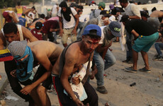 At least two people die and over 300 hurt as Venezuela border standoff turns deadly