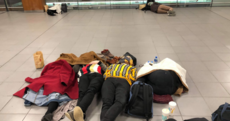Passengers sleep on the floor at Dublin Airport after snow and ice causes major delays
