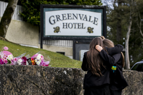Students from Holy Trinity College leave floral tributes outside The Greenvale Hotel in Cookstown