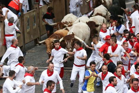 Bulls un down a street during the traditional San Fermin bull run in Pamplona.