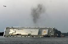 Rescuers contact crew members trapped inside capsized cargo ship