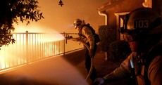 Thousands flee homes as wildfire rages on edge of Los Angeles