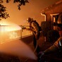 Thousands flee homes as wildfire rages on edge of Los Angeles