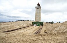 120-year-old lighthouse put on wheels to move it away from eroding Danish coastline