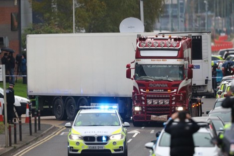 The container lorry where 39 people were found dead inside leaves Waterglade Industrial Park in Grays, Essex, heading towards Tilbury Docks under police escort.