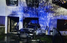 Investigation after car driven into vacant house and set on fire