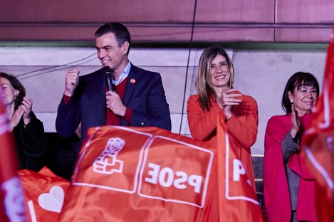 Spanish Prime Minister Pedro Sanchez thanks his supporters as they wave flags outside of the PSOE headquarters in Madrid