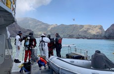 Divers search in polluted waters for bodies of two volcano victims