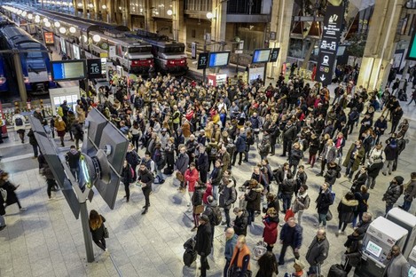 Commuters try to access metro trains at Gare du Nord train station in Paris, France