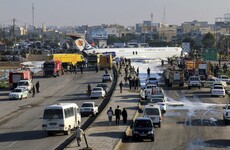 Passenger jet skids from runway on to street in Iran