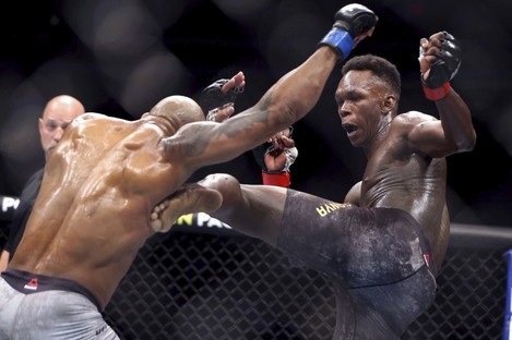 Yoel Romero is kicked by Israel Adesanya during the second round of their UFC 248 fight. 