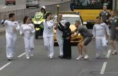 Nice try: Two kids try to take the Olympic torch
