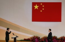 Hong Kong leader heckled on first day in office