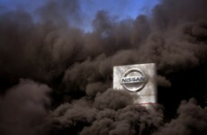 Nissan workers burn tyres at gate of Barcelona factory after closure announced