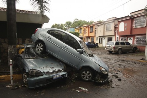 Vehicles stand damaged by an Acelhuate River flash flood at a neighborhood in San Salvador, El Salvado