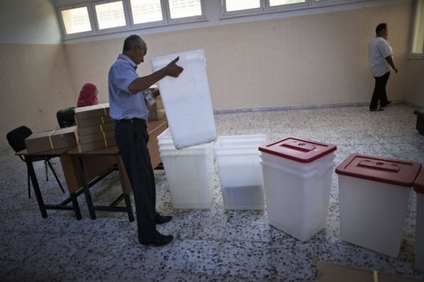 A worker prepares a polling station in Tripoli, Libya yesterday.