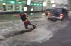 VIDEO: Man uses floods to surf down the street