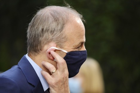 Micheal Martin adjusts his protective as he arrives at yesterday's summit