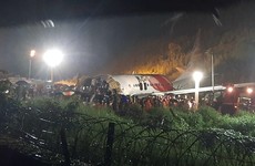 At least 16 dead and dozens injured after plane skids off runway in India