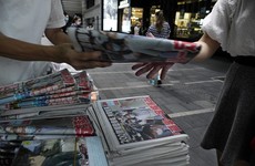 Hong Kong residents rush to buy pro-democracy newspaper following owner's arrest