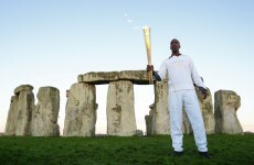 Games legend lights up Stonehenge with Olympic torch visit