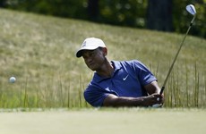 Tiger closes with 66 but faces work in US PGA playoffs