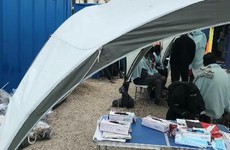 Migrants arriving wet and freezing after crossing English Channel are processed at 'rubble-strewn building site'