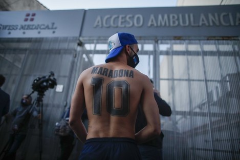 Football fans outside Clinica Olivos where Diego Maradona underwent surgery.