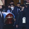 Fans gather along roads to bid farewell as Maradona buried in private ceremony