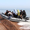 UK and France sign agreement to curb number of migrants crossing English Channel in boats