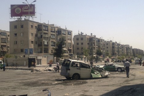 This citizen journalist image shows a destroyed vehicles after fighting between rebels and Syrian troops in the Yarmouk camp for Palestinian refugees in south Damascus