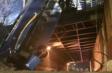 New York bus left hanging over bridge after crash