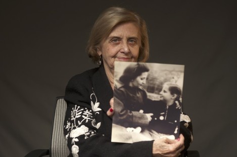 This photo provide by the World Jewish Congress, Tova Friedman, an 82-year-old Polish-born Holocaust survivor holding a photograph of herself as a child with her mother, who also survived the Nazi death camp Auschwitz. 