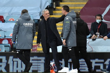 Jose Mourinho shares a joke with Aston Villa assistant manager John Terry before the game.