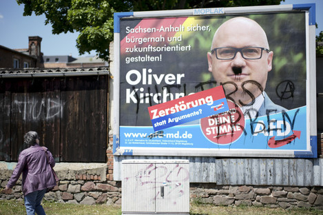 A vandalized election campaign poster for the far-right Alternative for Germany party showing the party's top candidate, Oliver Kirchner.