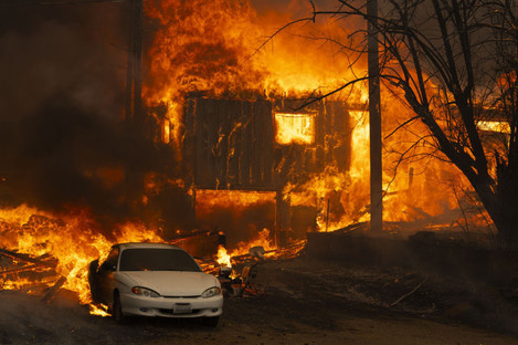 Greenville, California, USA: A home burns on Highway 89 south of Greenville, near Forgay Road during the Dixie fire.