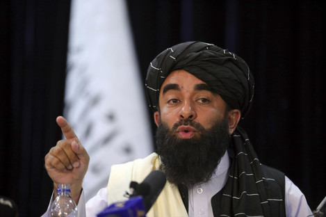 Taliban spokesman Zabihullah Mujahid speaks at a new conference. 