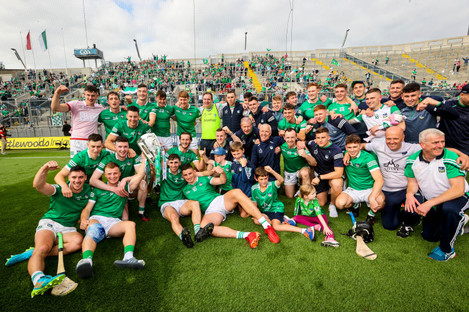 The Limerick staff and squad celebrate in front of Hill 16 with the Liam MacCarthy Cup.