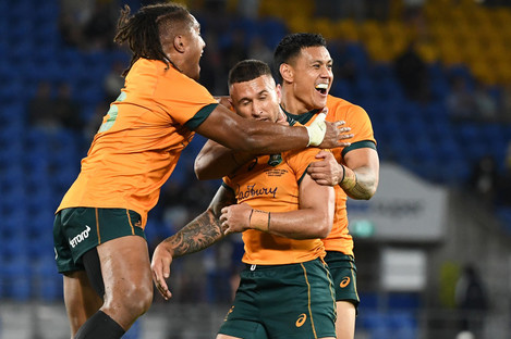 Quade Cooper is mobbed by team-mates after kicking the winning penalty for Australia against South Africa.