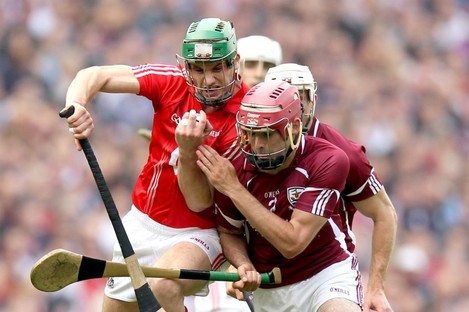 Cork's Eoin Cadogan and James Regan of Galway battle in yesterday's game.