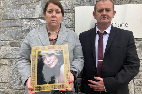 Melanie Sheehan and Barry Cleary, parents of Eve Cleary, holding a framed photograph of their daughter, outside Limerick Coroners Court.