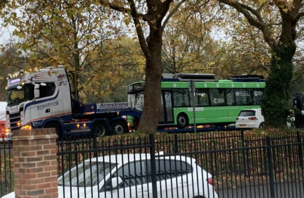 Image accompanying A photo shows a COP26 electric bus being towed by a diesel truck