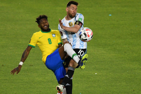 Lionel Messi of Argentina tangles with Brazil's Fred.