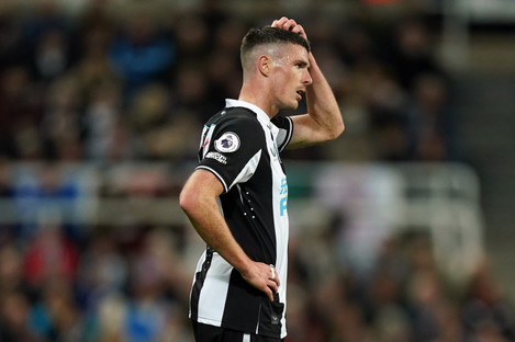 Ciaran Clark reacts to his red card. 