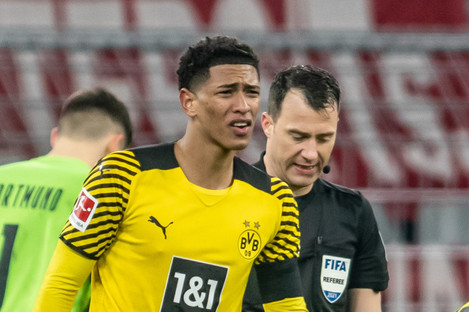 Dortmund's Jude Bellingham with referee Felix Zwayer in the background.