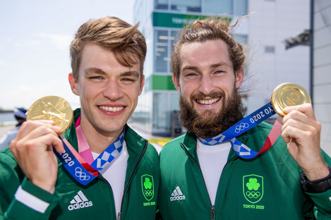 McCarthy (left) holds gold in his hand.