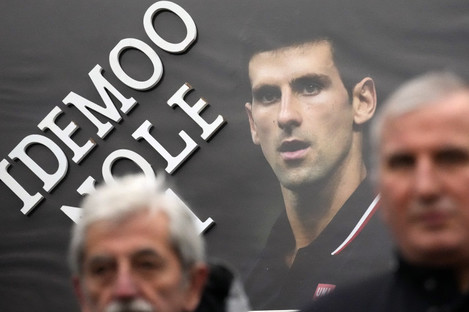 Supporters hold up a picture of Djokovic, reading: "Let's go Nole (Novak)" during a protest in Belgrade, Serbia today. 