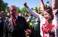 Russian ambassador to Poland hit with red paint by protesters