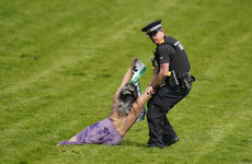 Animal activists taken away by police after running on to Epsom track